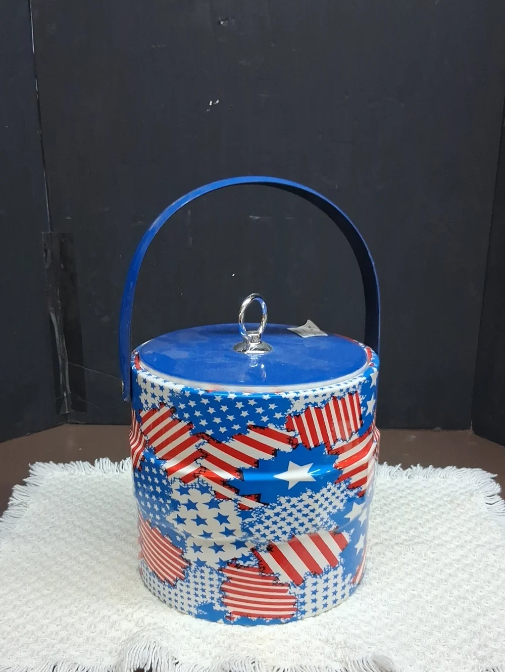 Patriotic Mr. Ice Bucket features a vibrant USA flag pattern& sturdy blue handle